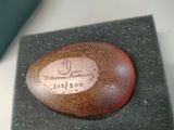 a stone with a name on it sitting on a piece of cloth