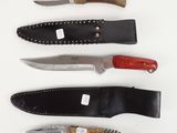 four different types of knives are lined up on a white surface