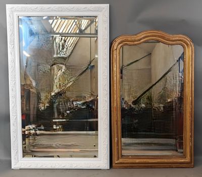 two mirrors that are sitting on a shelf next to each other