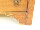a wooden dresser with a drawer on top of it