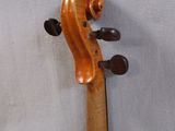 an old violin sitting on top of a table next to a wall