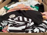 a cardboard box filled with clothes and other items