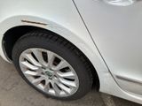 a close up of a white car with a broken tire