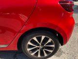 a close up of a red car parked in a parking lot