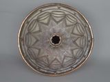 a silver plate with a star design on it