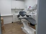 an image of a dentist ' s office with a chair and desk