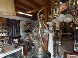 a statue of a woman holding a bird in a shop