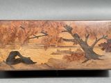 wooden box with a painting of a man and a dog sitting on the ground