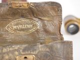 a close up of a piece of luggage with a camera in the background