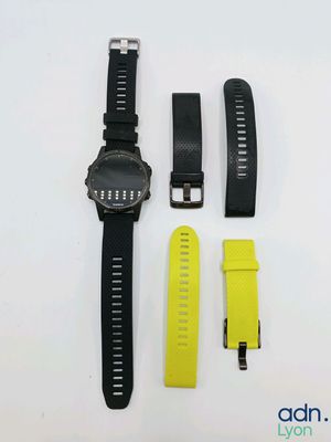 a black and yellow watch sitting next to a yellow watch band