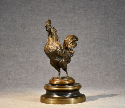 bronze statue of a rooster on a pedestal on a gray background