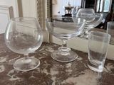 several empty wine glasses are sitting on a marble counter top