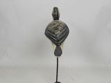 statue of a bird on a metal stand with a white background