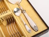 a set of silverware in a box with a spoon and fork