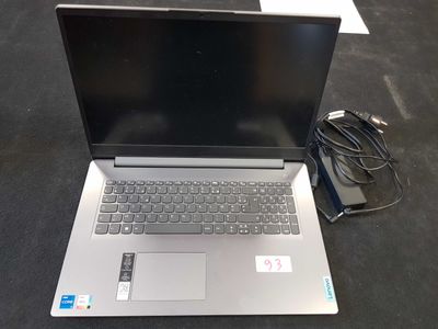 a laptop that is sitting on the floor with a charger