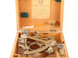 a wooden box with a pair of scissors in it