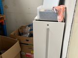 a refrigerator that is sitting in the corner of a room