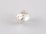 a close up of a silver ring on a white background