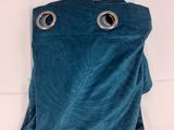 a blue curtain hanging on the wall in a room