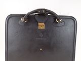 the black briefcase is sitting on a white surface
