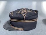 a hat that is sitting on the floor next to a pair of shoes