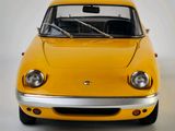 a yellow car that is sitting on a white surface