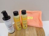 two bottles of lotion and a towel on a cutting board