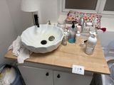 a white sink sitting on top of a wooden counter in a bathroom