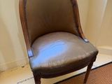 brown leather chair in front of a window in a room