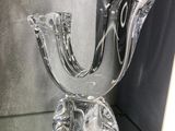 a glass vase that is sitting on a glass table