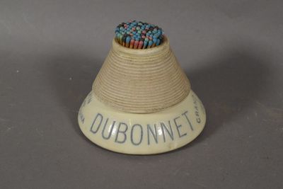 a small white object with a blue and red bead in it