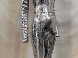 the mannequin is made of shiny silver sequins