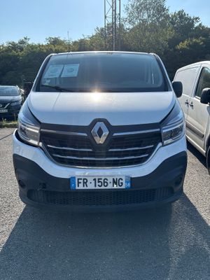 the front of a white van parked in a parking lot