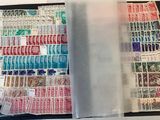 many different stamps in a folder on the table