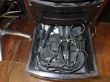 a chair that has a table with a bunch of wires in it