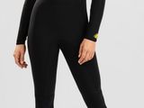 a woman in a black wetsuit posing for the camera