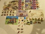 many different stamps on a table with a shadow of a person