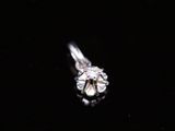 a close up of a diamond ring on a black surface