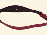 a close up of a red leather belt on a white background