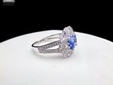 an image of a blue and white diamond ring on a white plate