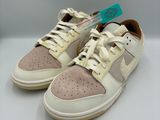 beige and white sneakers with a blue tag on the side of the shoe
