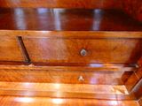 a wooden dresser with a drawer on top of it