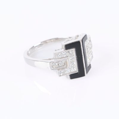 a close up of a ring with a black and white stone