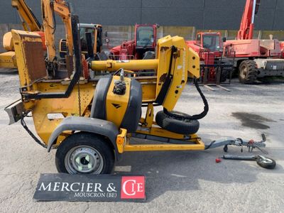 a small yellow machine that is parked in the parking lot