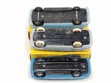 three toy trains sitting on top of each other on a table