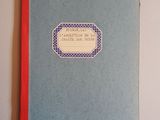 a blue book with a label on it on a table