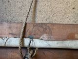 a piece of wood with a rope hanging on it