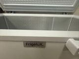 a white refrigerator with the door open and a sign that says frigleuxx