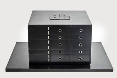 a black box that has a bunch of drawers on top of it