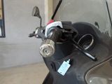 a close up of a motorcycle ' s windshield with a tag on it